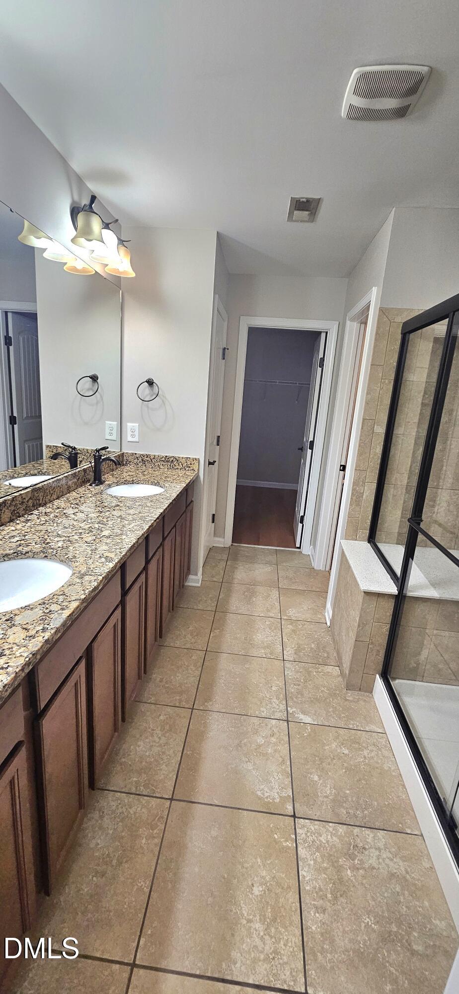 313 Brier Crossings Loop Durham, NC 27703 - Photo 18 of 27 a bathroom with a granite countertop sink and mirror