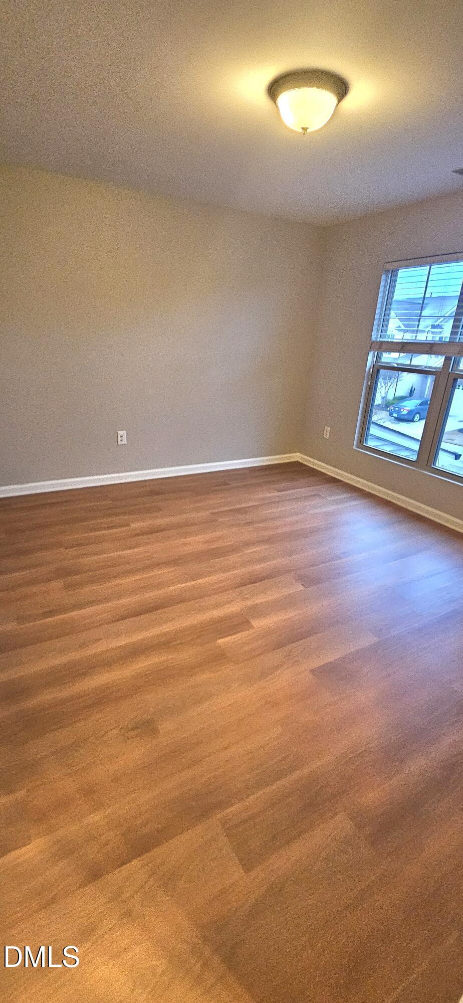 313 Brier Crossings Loop Durham, NC 27703 - Photo 23 of 27 an empty room with wooden floor and windows