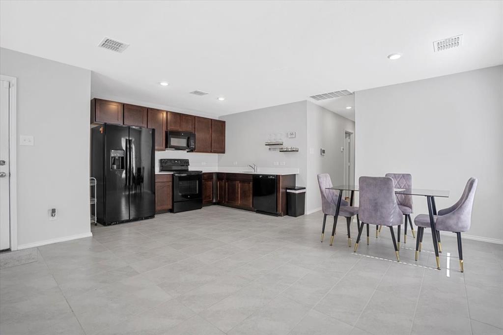 8730 Texas Risinger Drive Fort Worth, TX 76123 - Photo 11 of 19 a large kitchen with a table and chairs