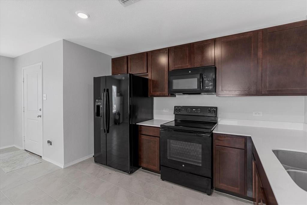 8730 Texas Risinger Drive Fort Worth, TX 76123 - Photo 13 of 19 a kitchen with stainless steel appliances granite countertop a refrigerator and a stove top oven