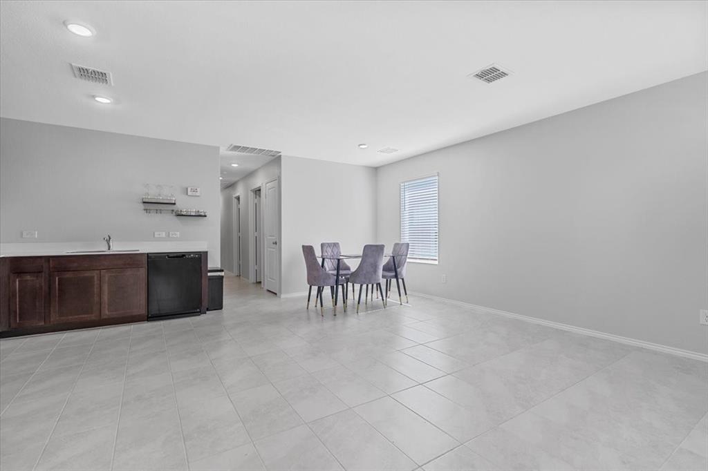 8730 Texas Risinger Drive Fort Worth, TX 76123 - Photo 14 of 19 a view of a kitchen with a dining table and chairs