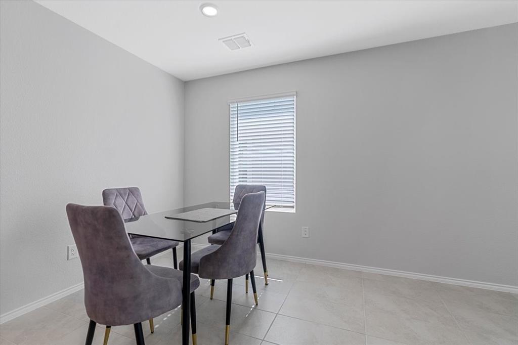 8730 Texas Risinger Drive Fort Worth, TX 76123 - Photo 15 of 19 a view of a dining room with furniture and window