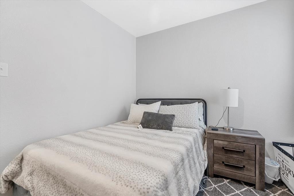 8730 Texas Risinger Drive Fort Worth, TX 76123 - Photo 19 of 19 a bedroom with a bed and a night stand