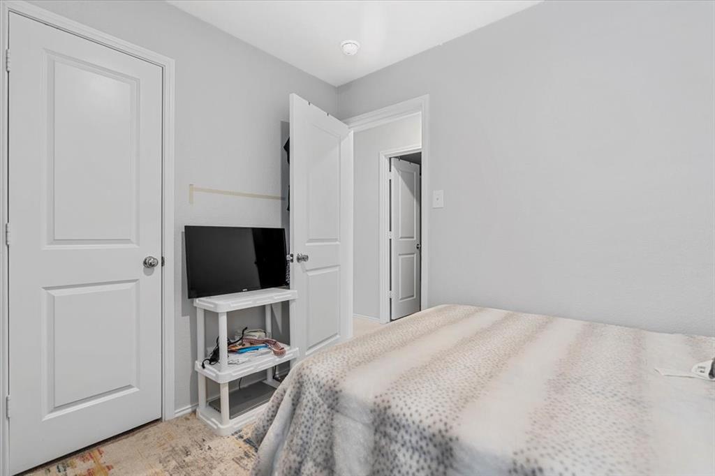 8730 Texas Risinger Drive Fort Worth, TX 76123 - Photo 3 of 19 a bedroom with a bed and a flat screen tv