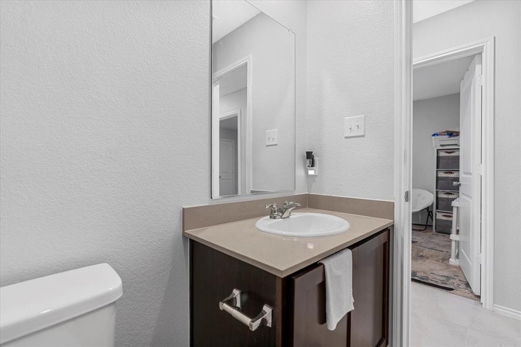 8730 Texas Risinger Drive Fort Worth, TX 76123 - Photo 5 of 19 a bathroom with a sink and a toilet