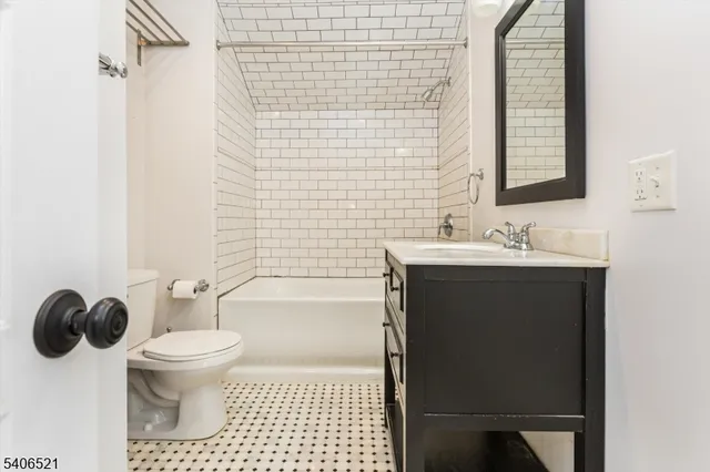 a bathroom with a sink toilet vanity and shower