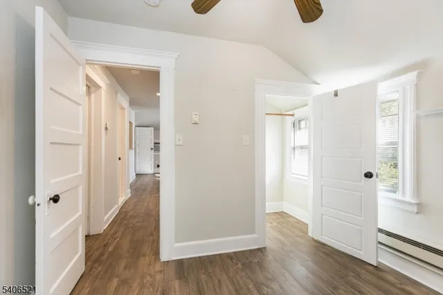 a view of a hallway with wooden floor
