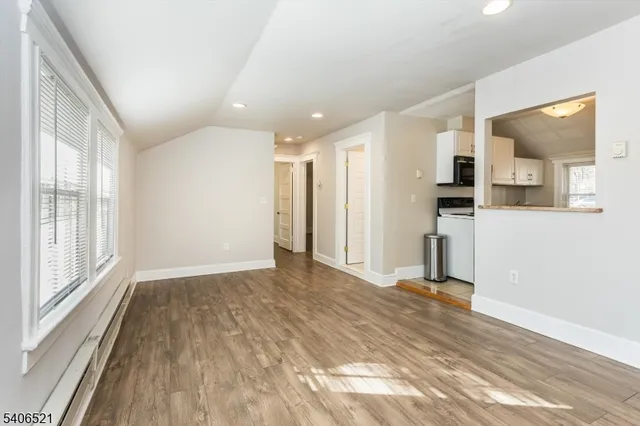 a view of a kitchen with a sink and a refrigerator