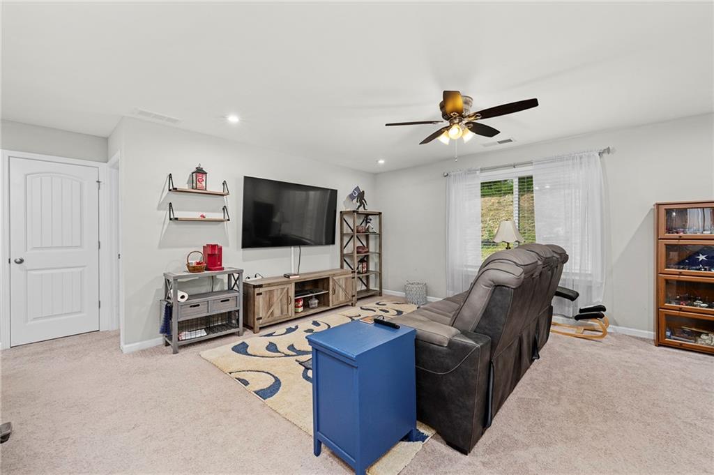 230 Augusta Walk Canton, GA 30114 - Photo 24 of 56 a living room with furniture and a flat screen tv
