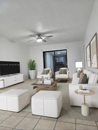a living room with furniture and a potted plant