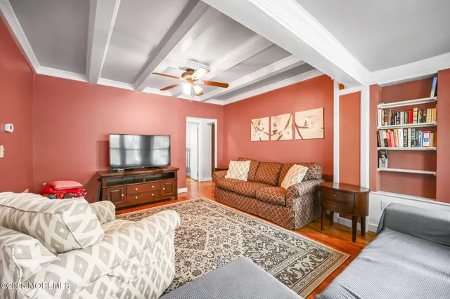 a bedroom with furniture and a flat screen tv