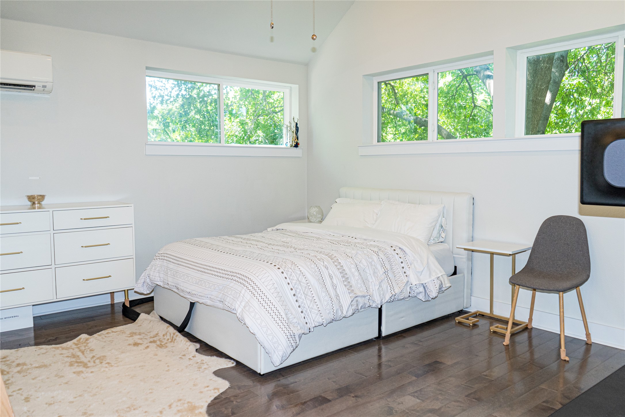 2714 East 3rd Street, Unit 2 Austin, TX 78702 - Photo 10 of 13 a bedroom with a bed chair and window