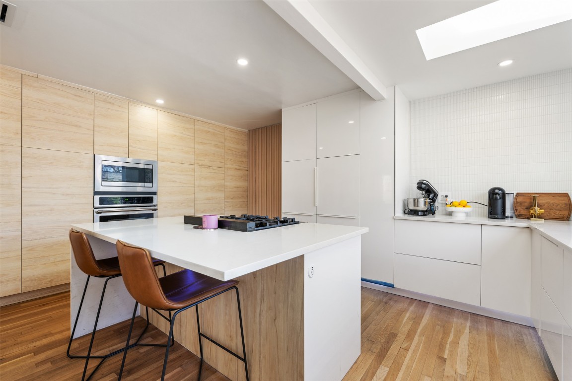 1403 Palo Duro Road Austin, TX 78757 - Photo 12 of 34 a kitchen with a table chairs and a refrigerator