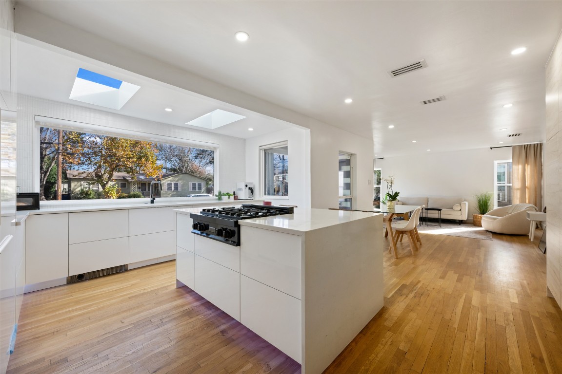 1403 Palo Duro Road Austin, TX 78757 - Photo 15 of 34 a large white kitchen with wooden floor and a large window