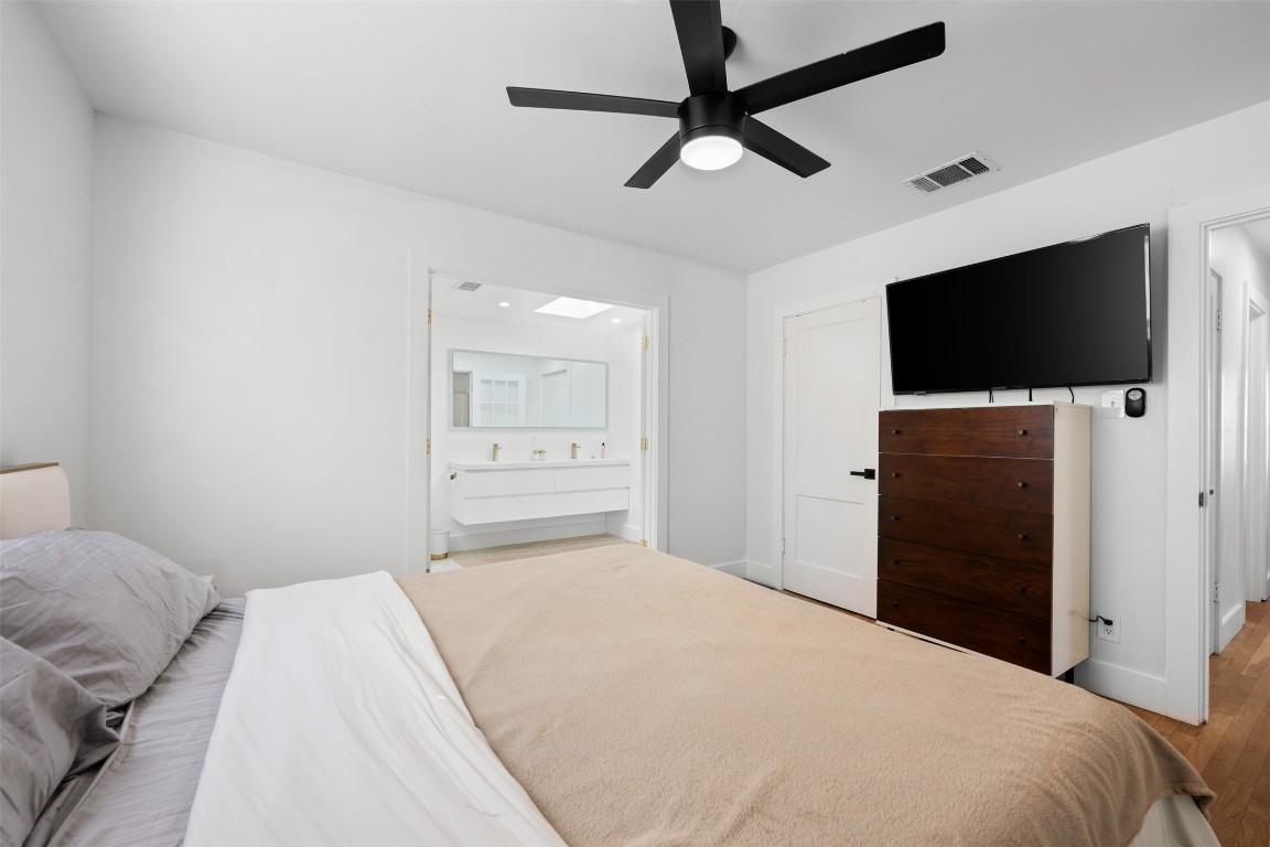 1403 Palo Duro Road Austin, TX 78757 - Photo 17 of 34 a bedroom with a bed and a flat screen tv