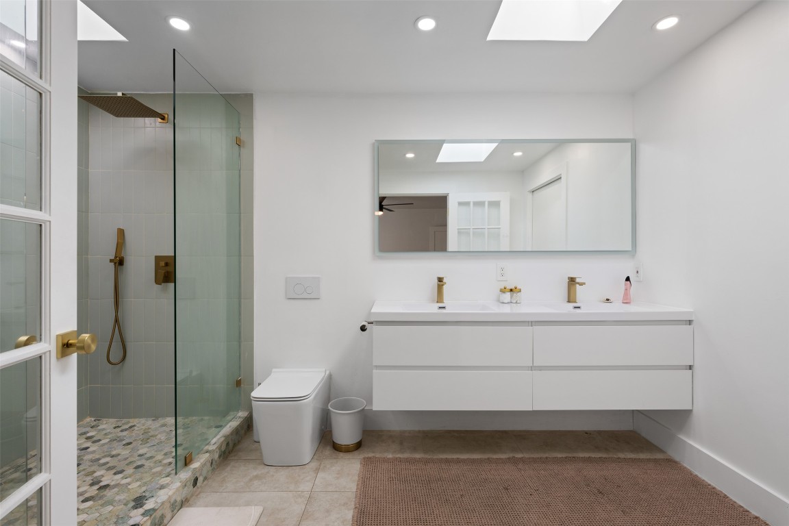 1403 Palo Duro Road Austin, TX 78757 - Photo 18 of 34 a bathroom with a sink toilet and shower