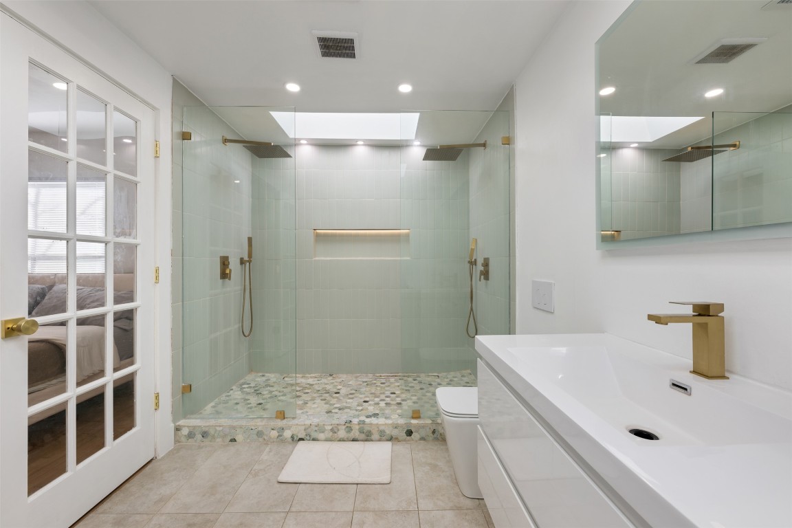 1403 Palo Duro Road Austin, TX 78757 - Photo 20 of 34 a bathroom with a sink a toilet and shower