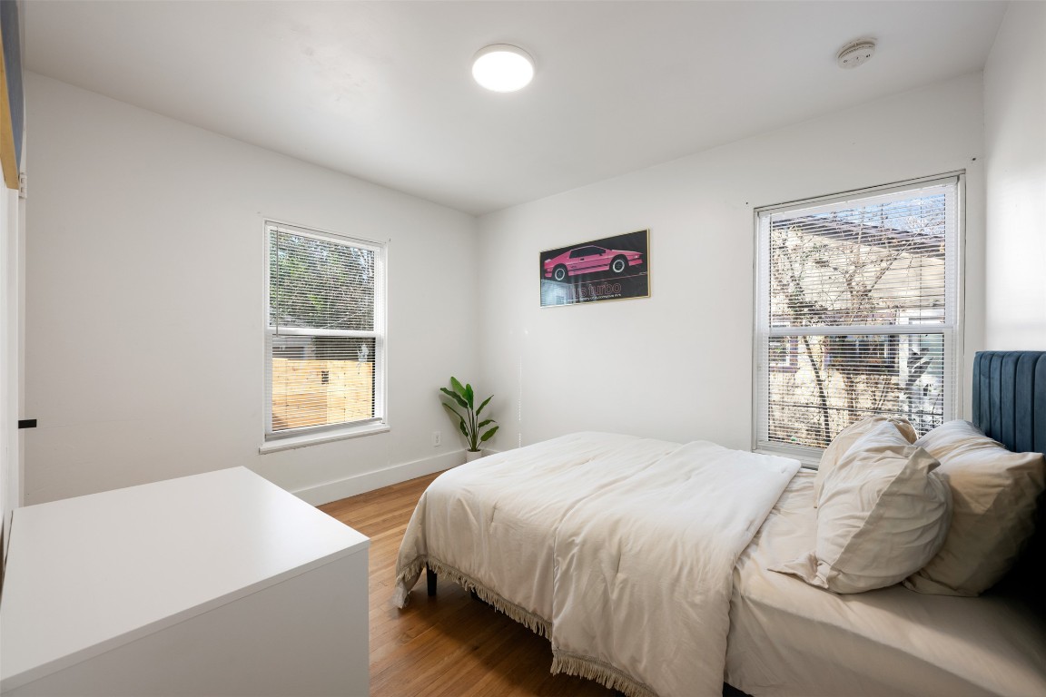 1403 Palo Duro Road Austin, TX 78757 - Photo 22 of 34 a bedroom with a bed and a large window with outer view