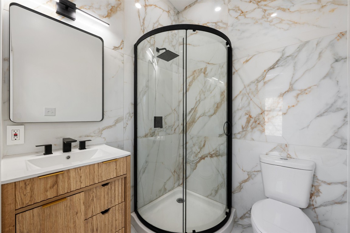 1403 Palo Duro Road Austin, TX 78757 - Photo 29 of 34 a bathroom with a toilet sink and mirror