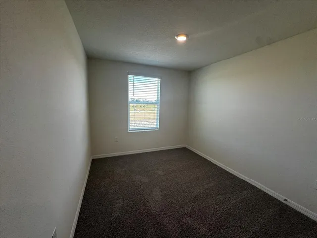 a view of a bathroom with a glass door and a bathroom