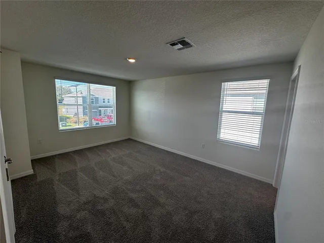 a view of an empty room and a window