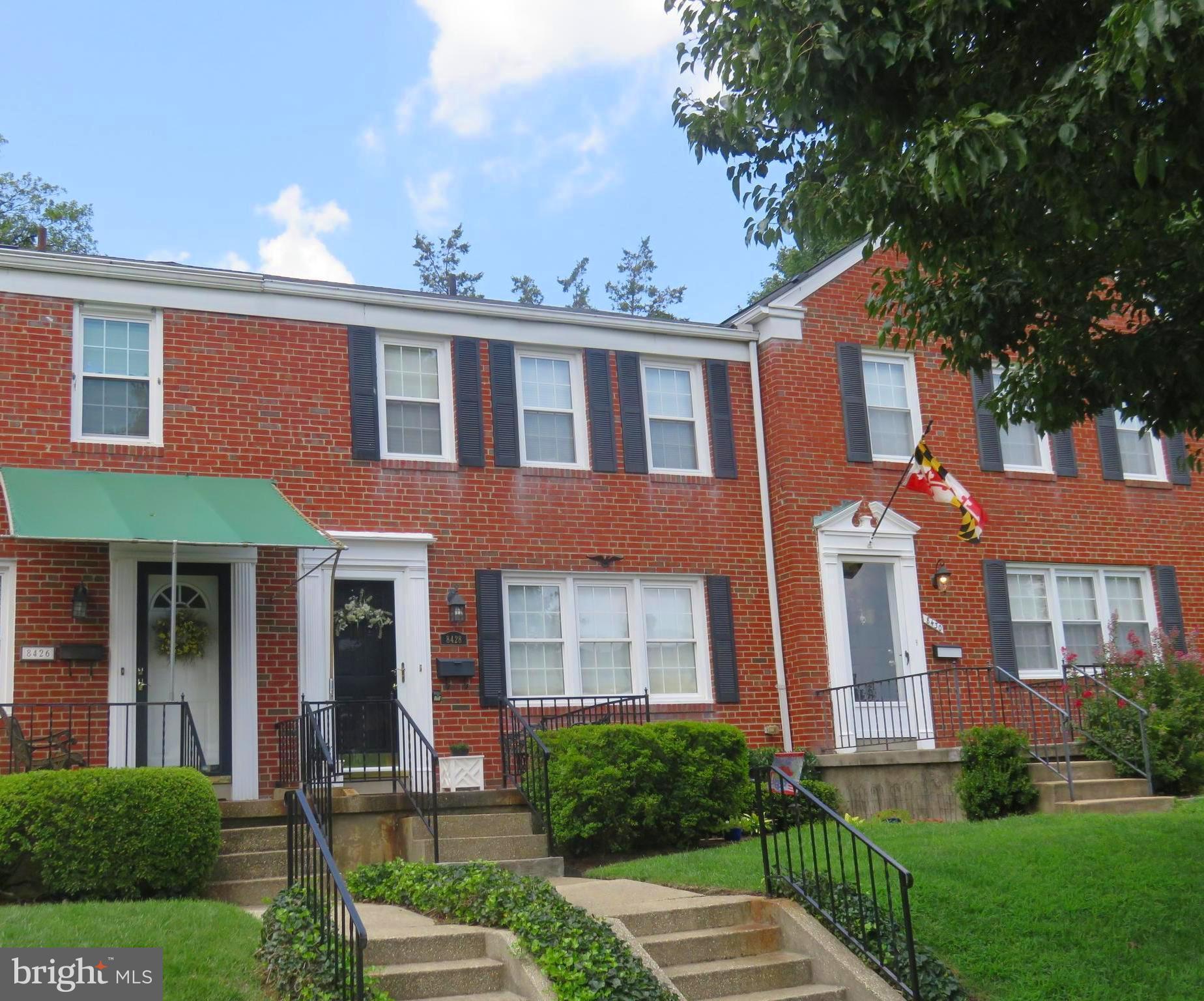 8428 Pleasant Plains Road Baltimore, MD 21286 - Photo 1 of 29 front view of a brick house with a yard