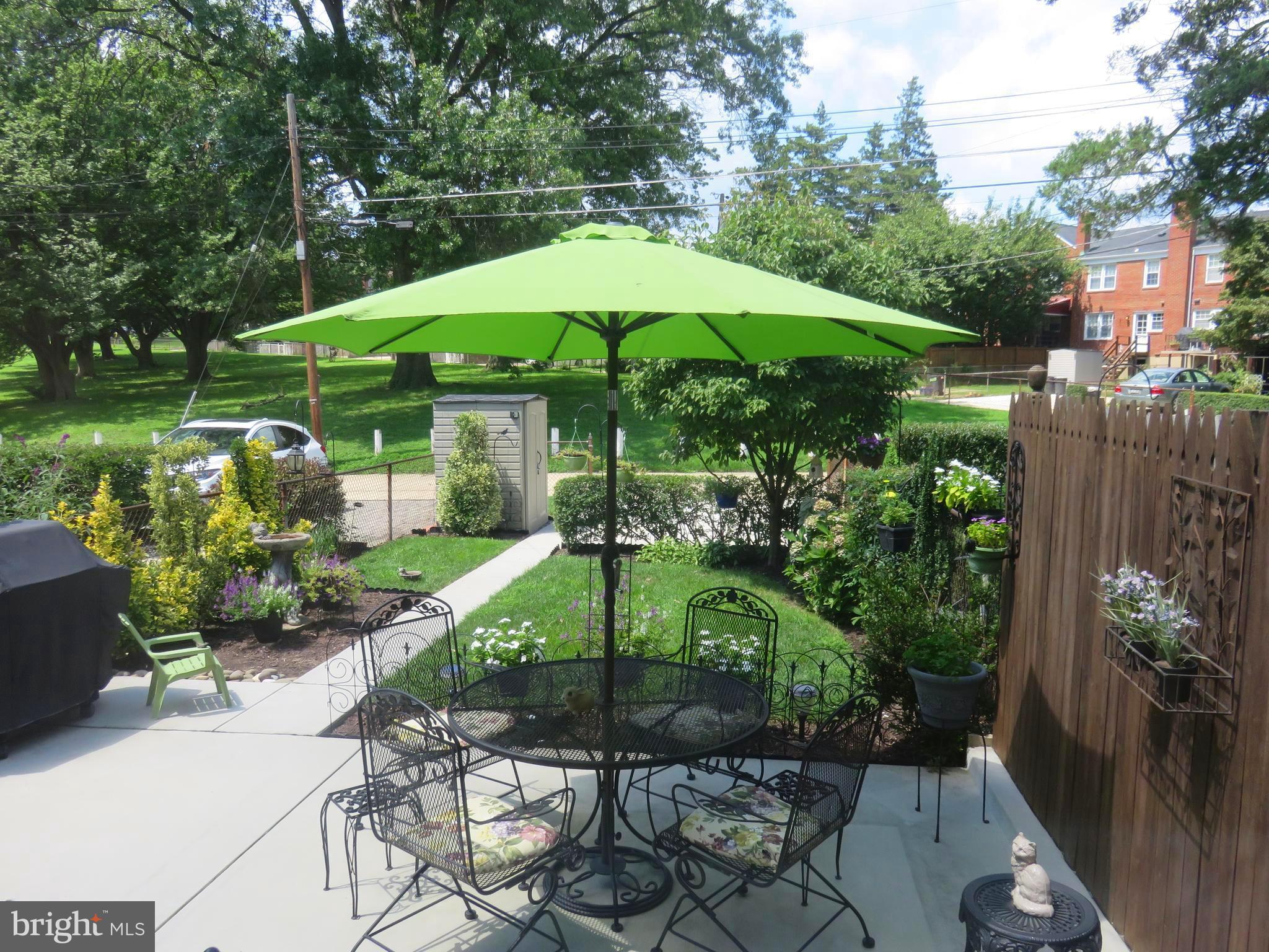 8428 Pleasant Plains Road Baltimore, MD 21286 - Photo 2 of 29 a view of a chair and table with umbrella in the garden