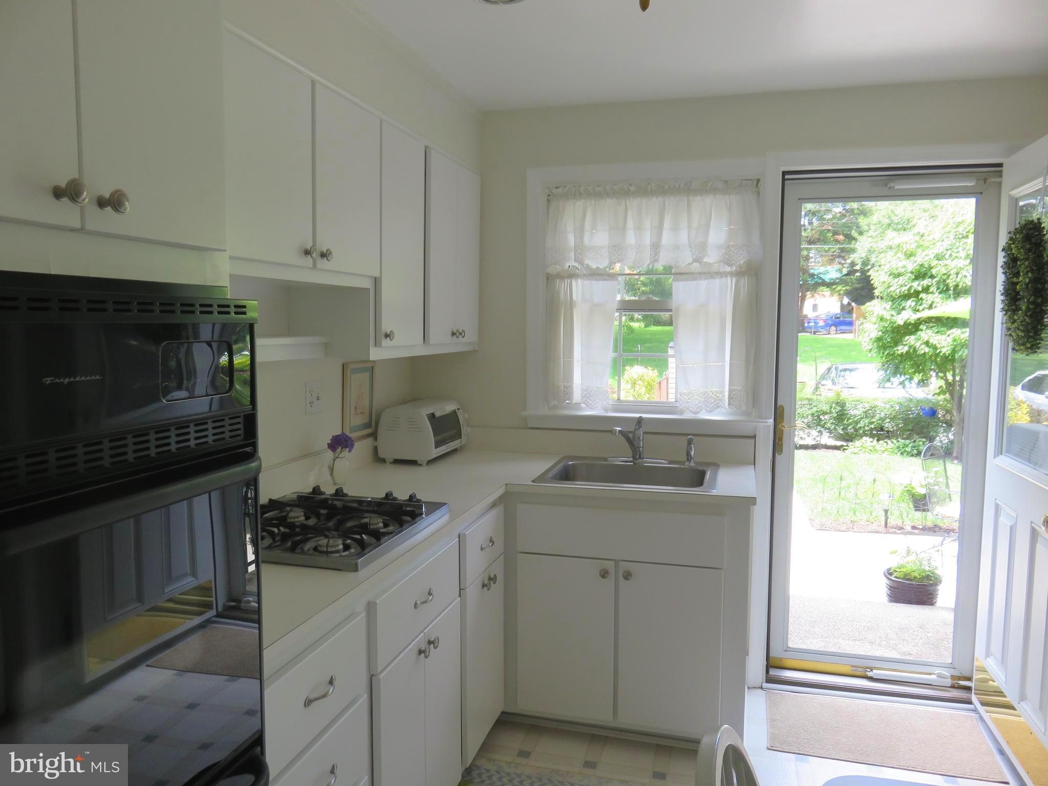 8428 Pleasant Plains Road Baltimore, MD 21286 - Photo 12 of 29 a kitchen with a stove a sink and a window