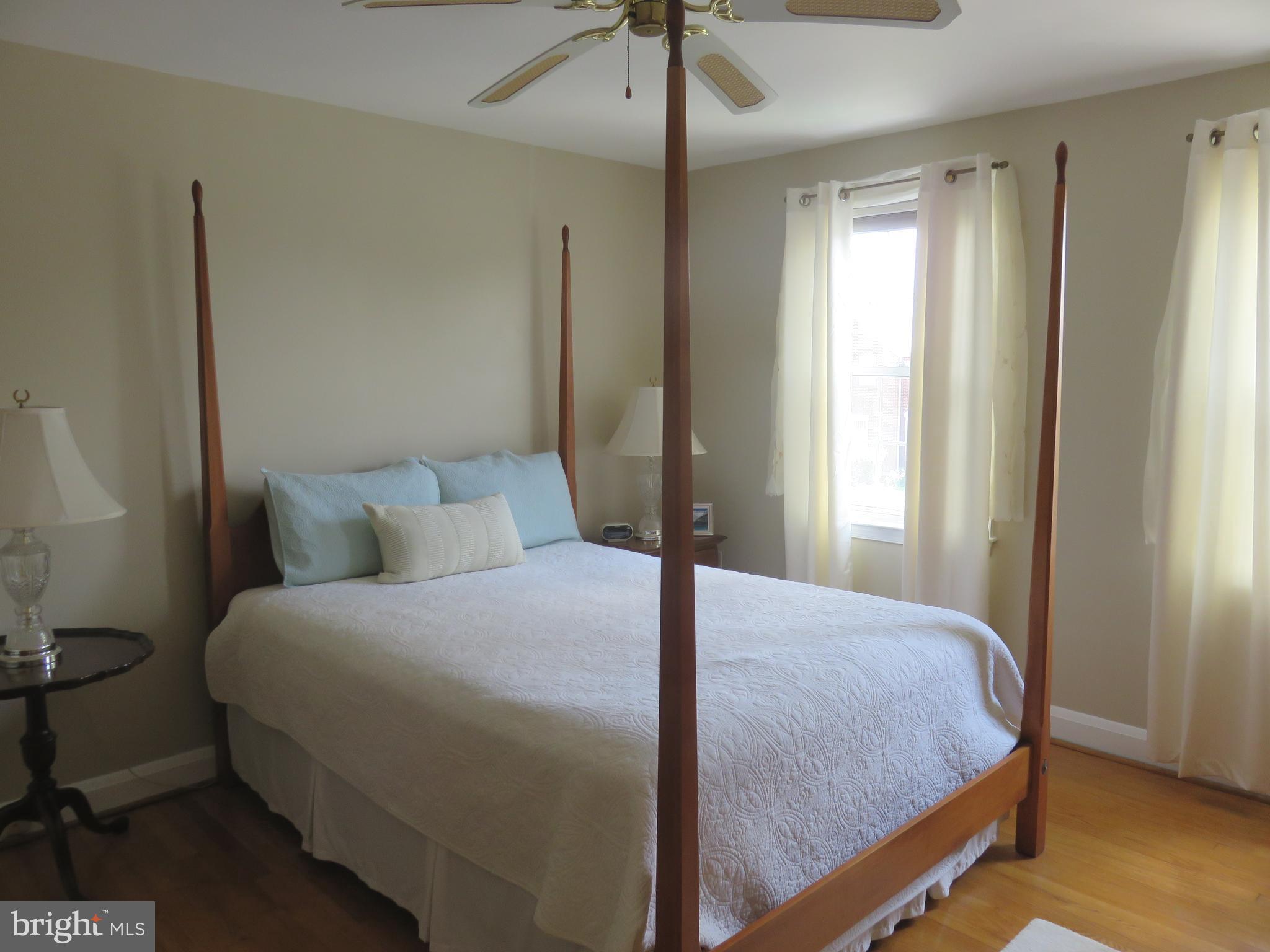 8428 Pleasant Plains Road Baltimore, MD 21286 - Photo 13 of 29 a bedroom with a bed and a chandelier