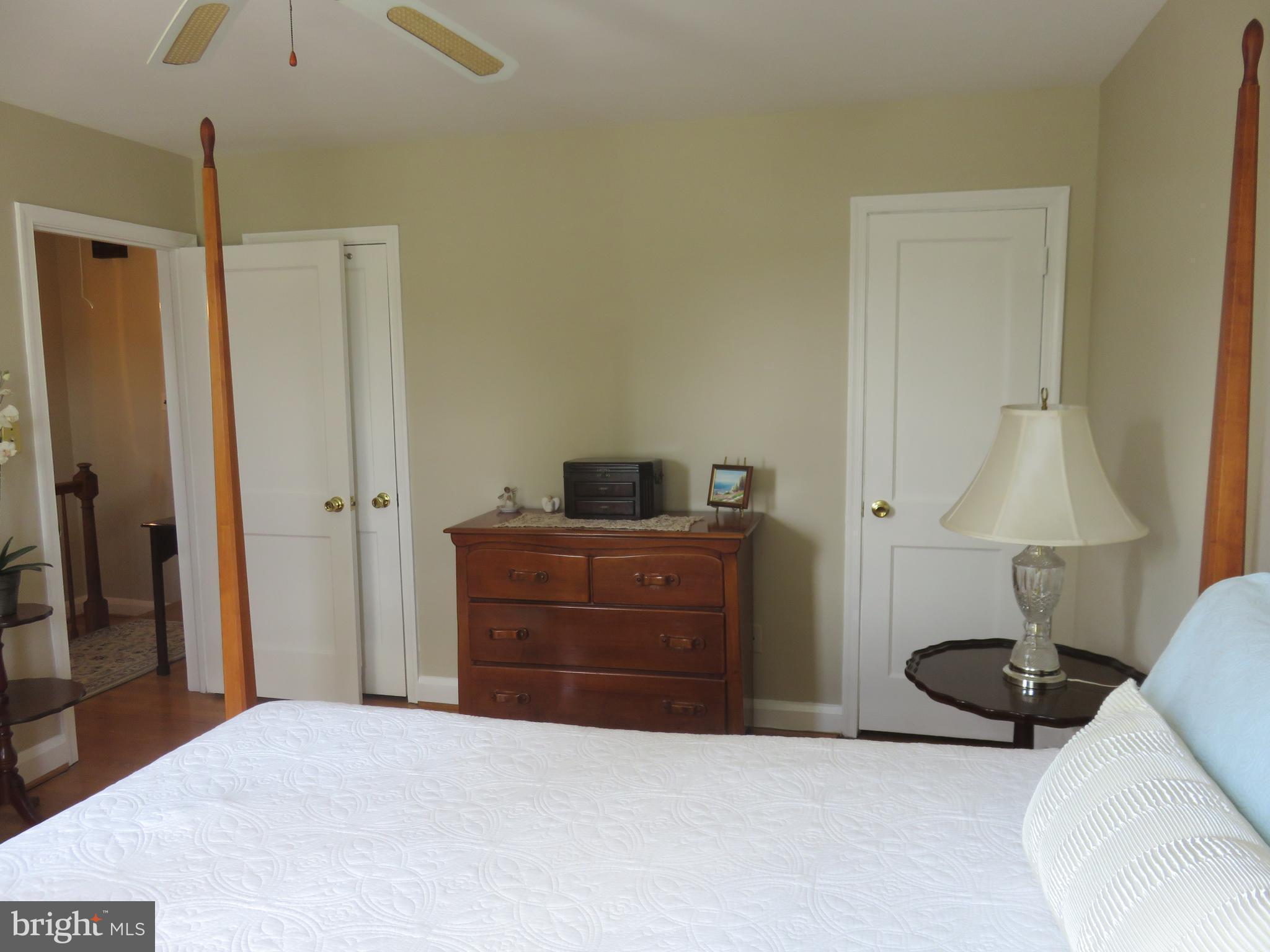 8428 Pleasant Plains Road Baltimore, MD 21286 - Photo 14 of 29 a bedroom with a bed and a lamp on the dresser