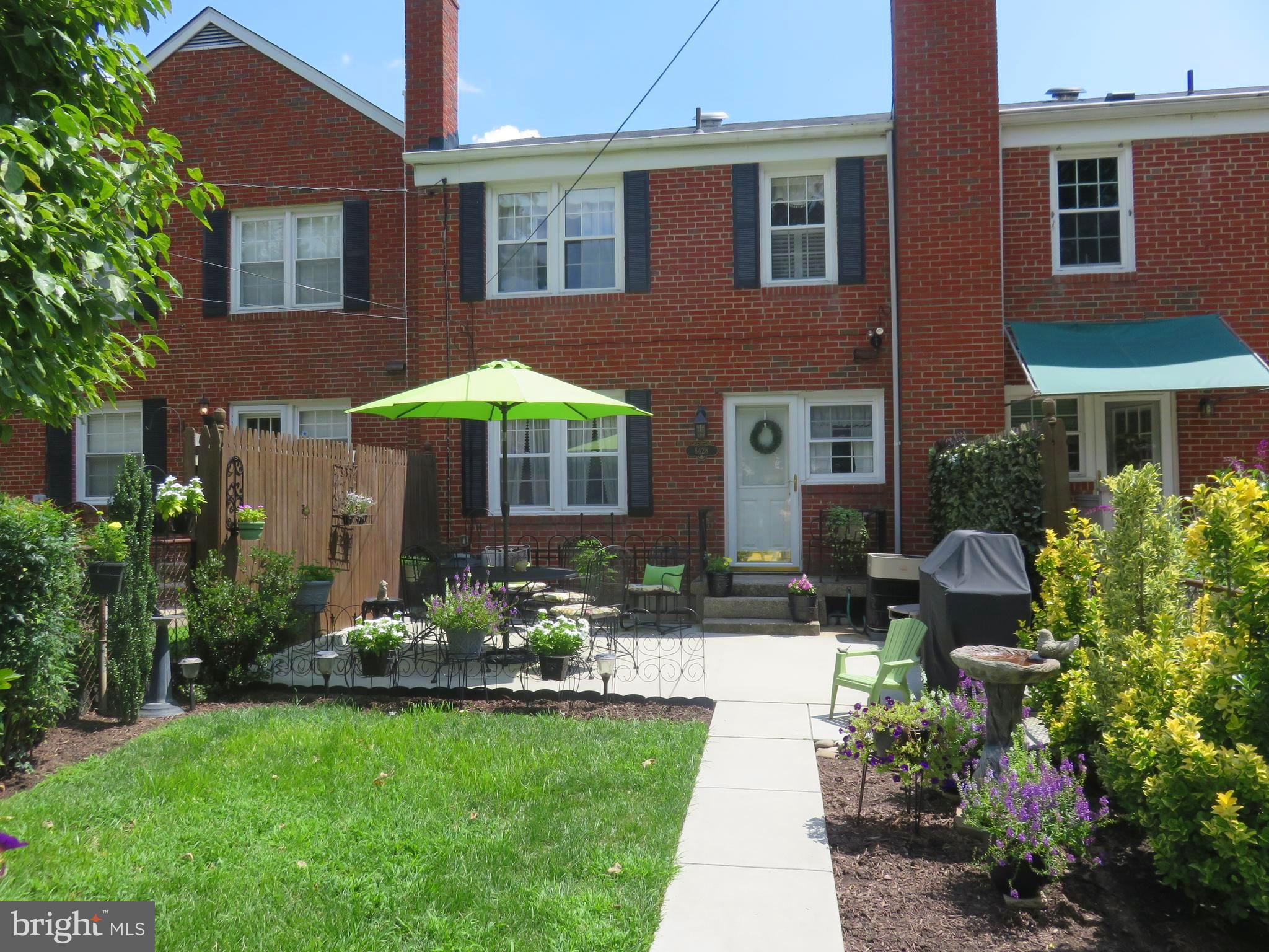 8428 Pleasant Plains Road Baltimore, MD 21286 - Photo 3 of 29 a patio with a table and chairs under an umbrella