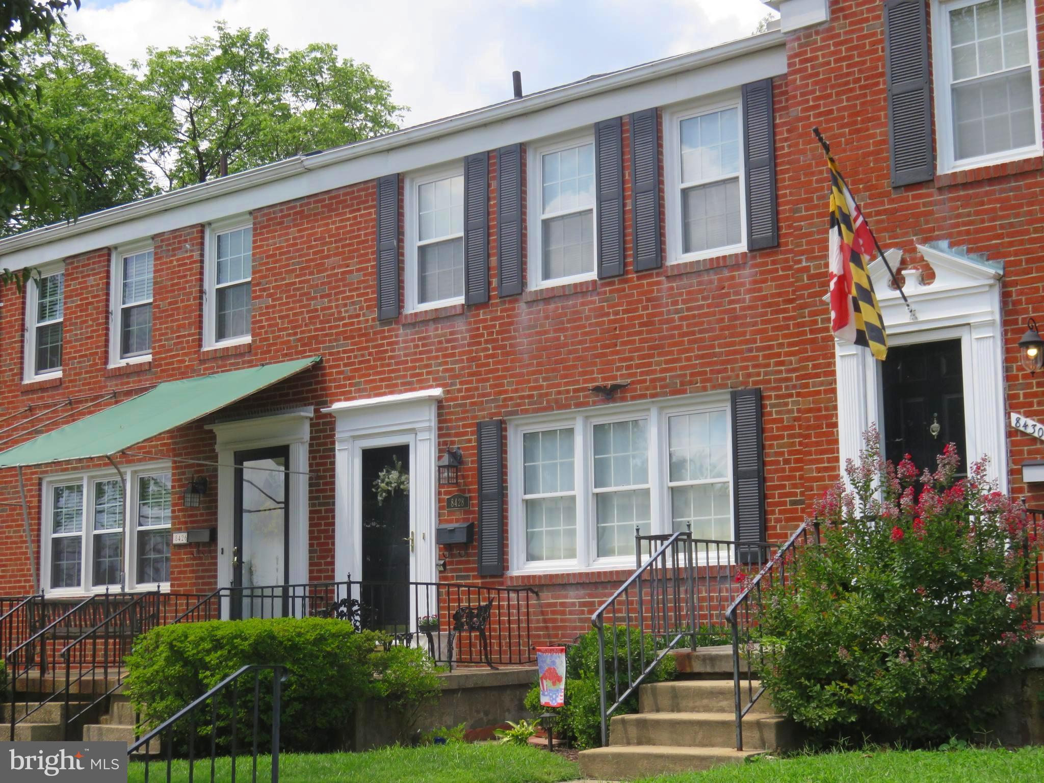 8428 Pleasant Plains Road Baltimore, MD 21286 - Photo 23 of 29 a front view of a brick house with a yard