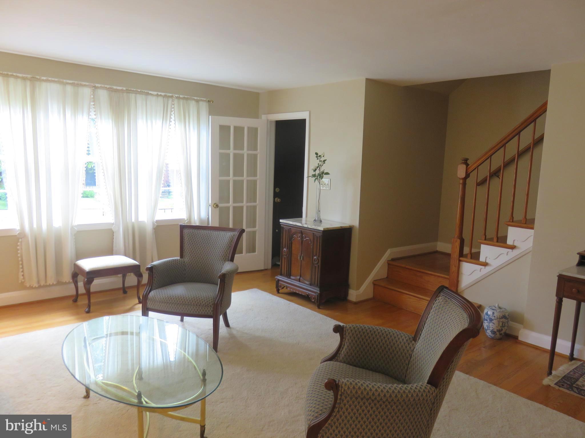 8428 Pleasant Plains Road Baltimore, MD 21286 - Photo 4 of 29 a living room with furniture a dining table and a potted plant