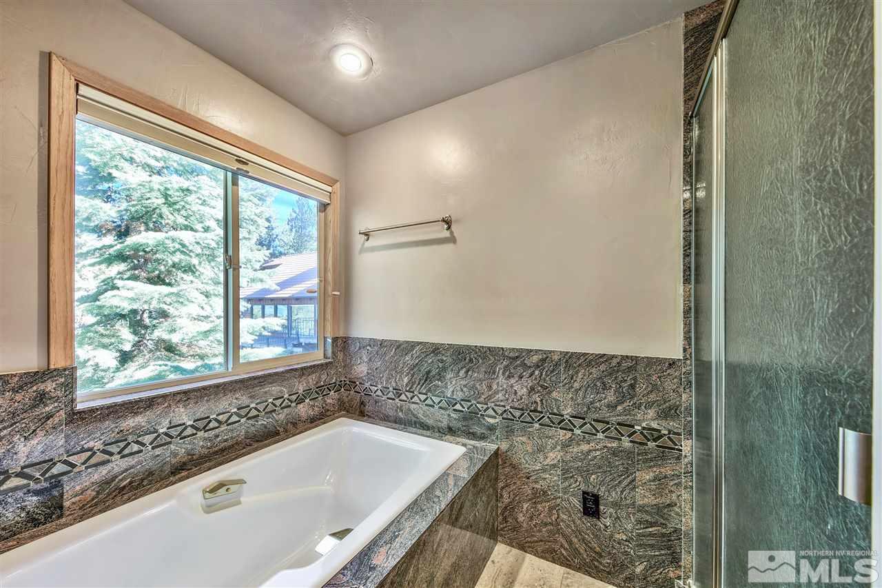 218 Terrace View Drive Stateline, NV 89449 - Photo 11 of 22 a bath tub sitting in a bathroom next to a window