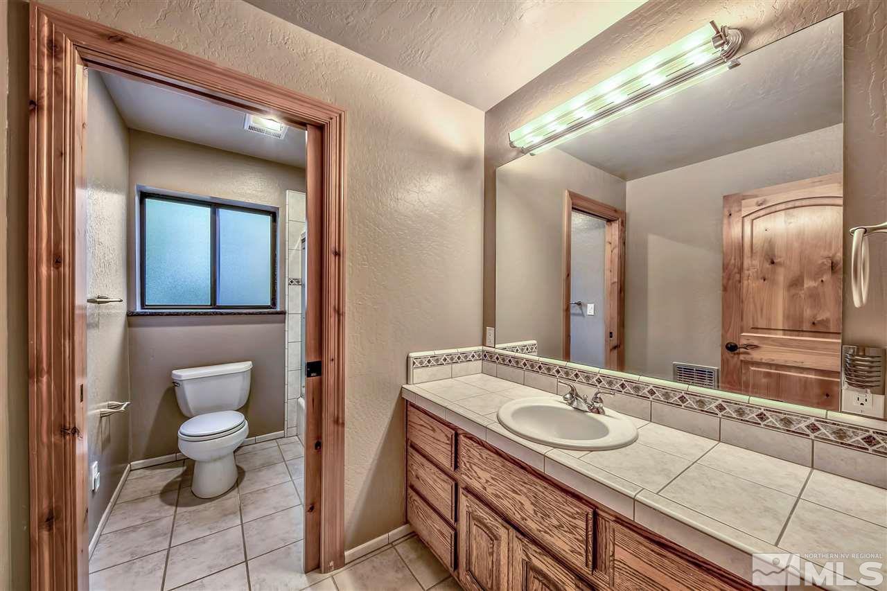 218 Terrace View Drive Stateline, NV 89449 - Photo 14 of 22 a bathroom with a granite countertop sink and a mirror