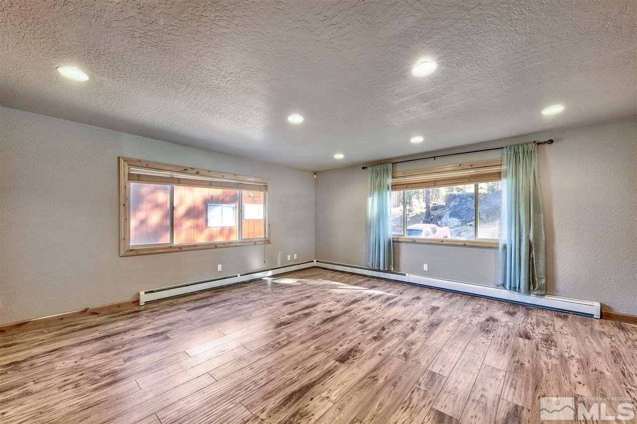 218 Terrace View Drive Stateline, NV 89449 - Photo 16 of 22 an empty room with wooden floor and windows
