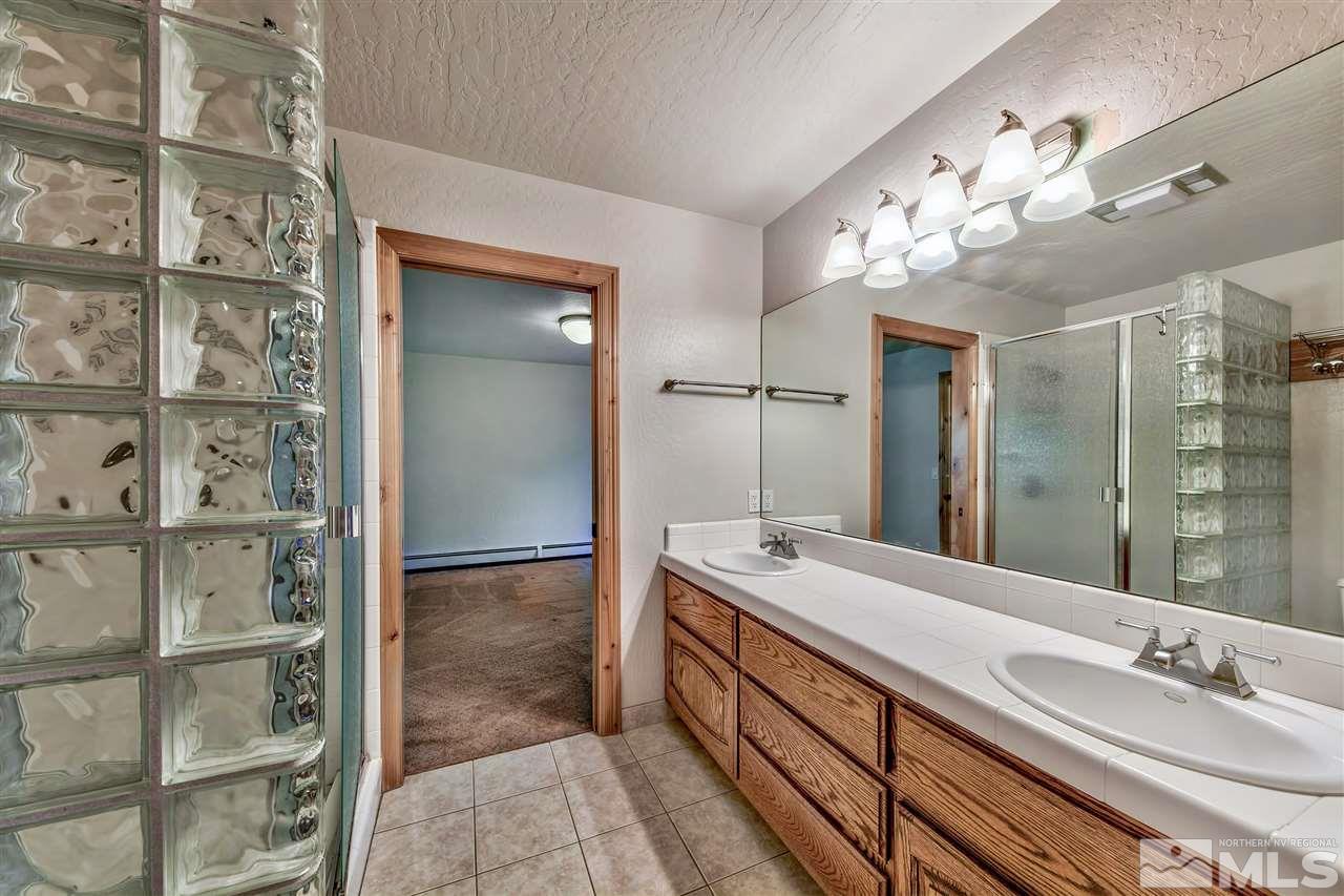 218 Terrace View Drive Stateline, NV 89449 - Photo 19 of 22 a bathroom with a double vanity sink and a mirror