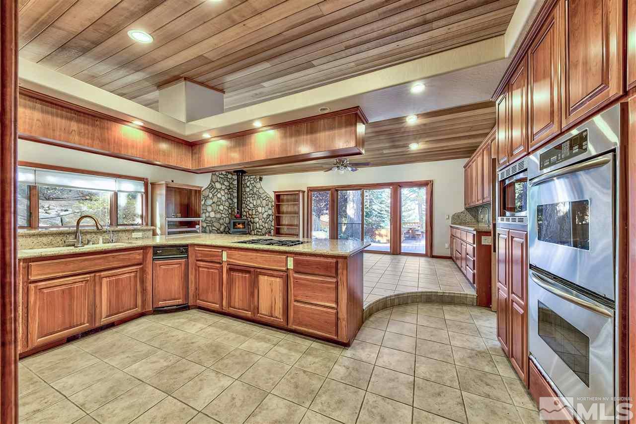 218 Terrace View Drive Stateline, NV 89449 - Photo 7 of 22 a large kitchen with stainless steel appliances granite countertop a stove and cabinets