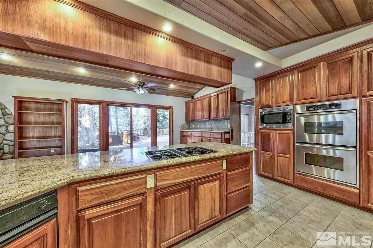 218 Terrace View Drive Stateline, NV 89449 - Photo 8 of 22 a kitchen with stainless steel appliances granite countertop a stove sink and cabinets