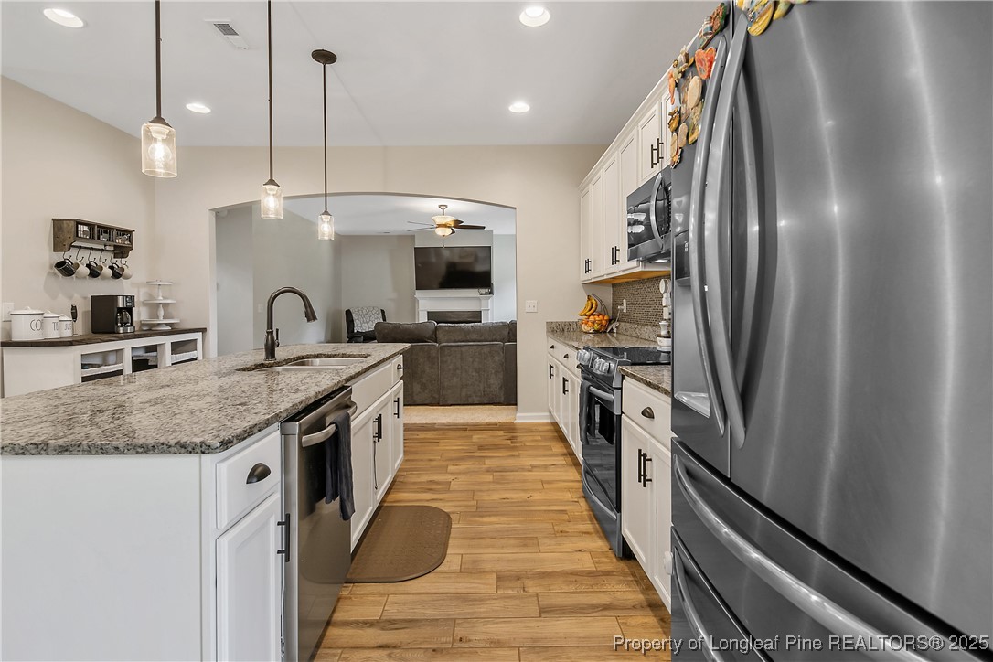 101 Shepard Drive Linden, NC 28356 - Photo 18 of 50 a kitchen with stainless steel appliances granite countertop a sink a stove and a refrigerator