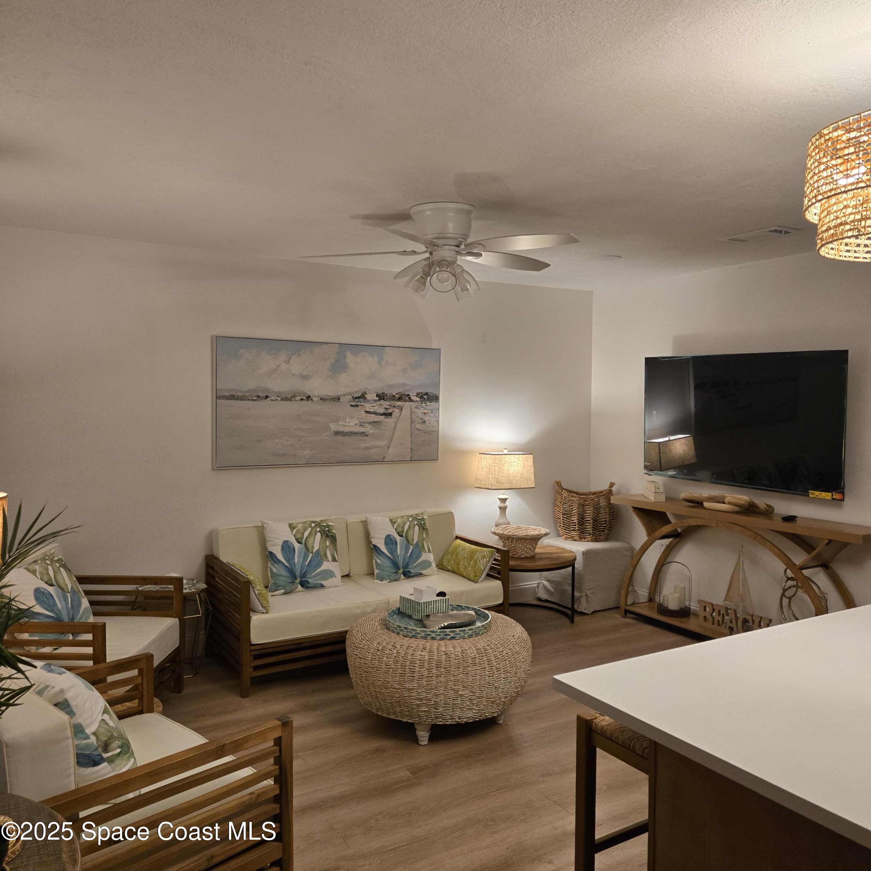 8761 Ilex Court Cape Canaveral, FL 32920 - Photo 11 of 41 a living room with furniture and a flat screen tv