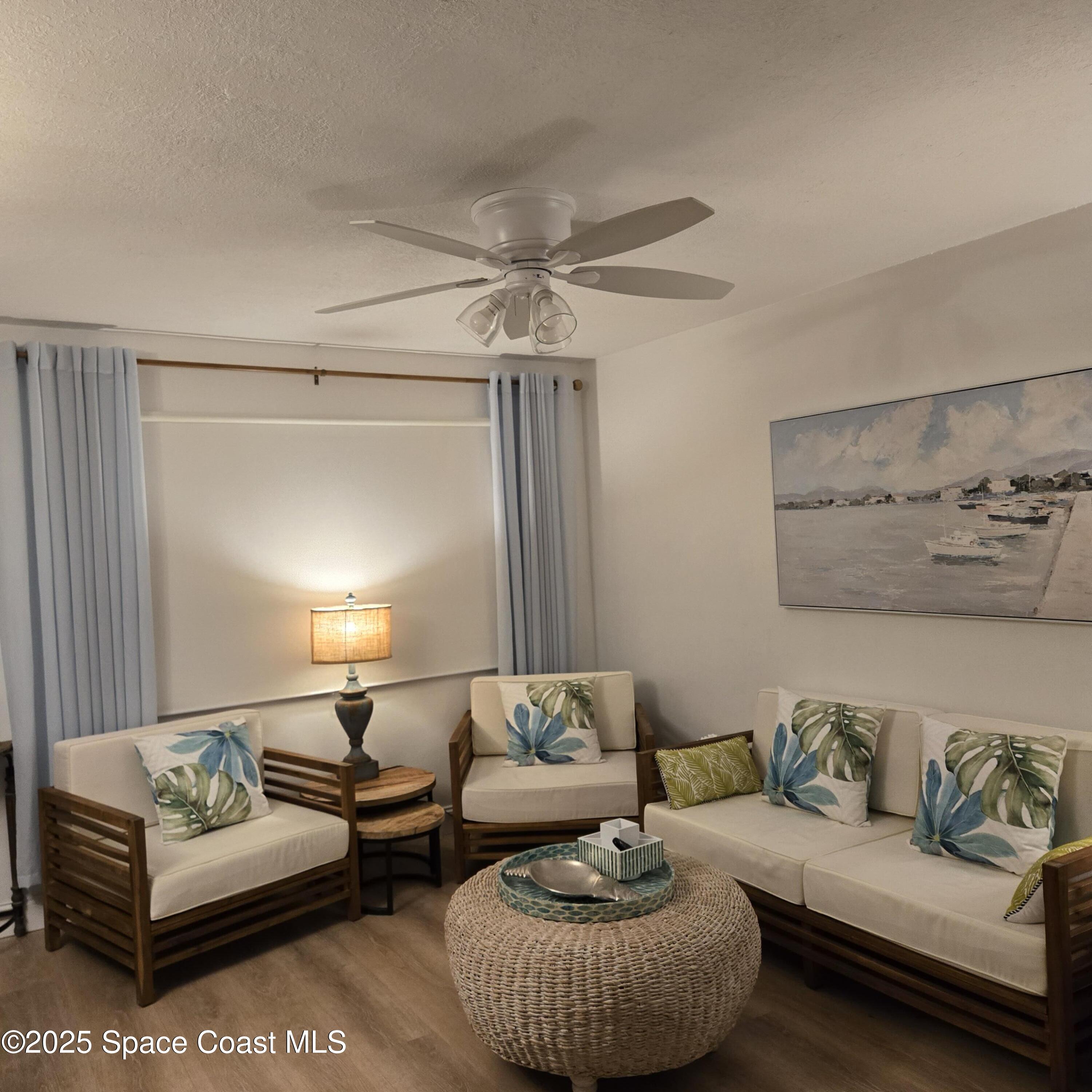 8761 Ilex Court Cape Canaveral, FL 32920 - Photo 12 of 41 a living room with furniture and a glass door