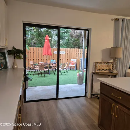 a view of a backyard with a table and chairs