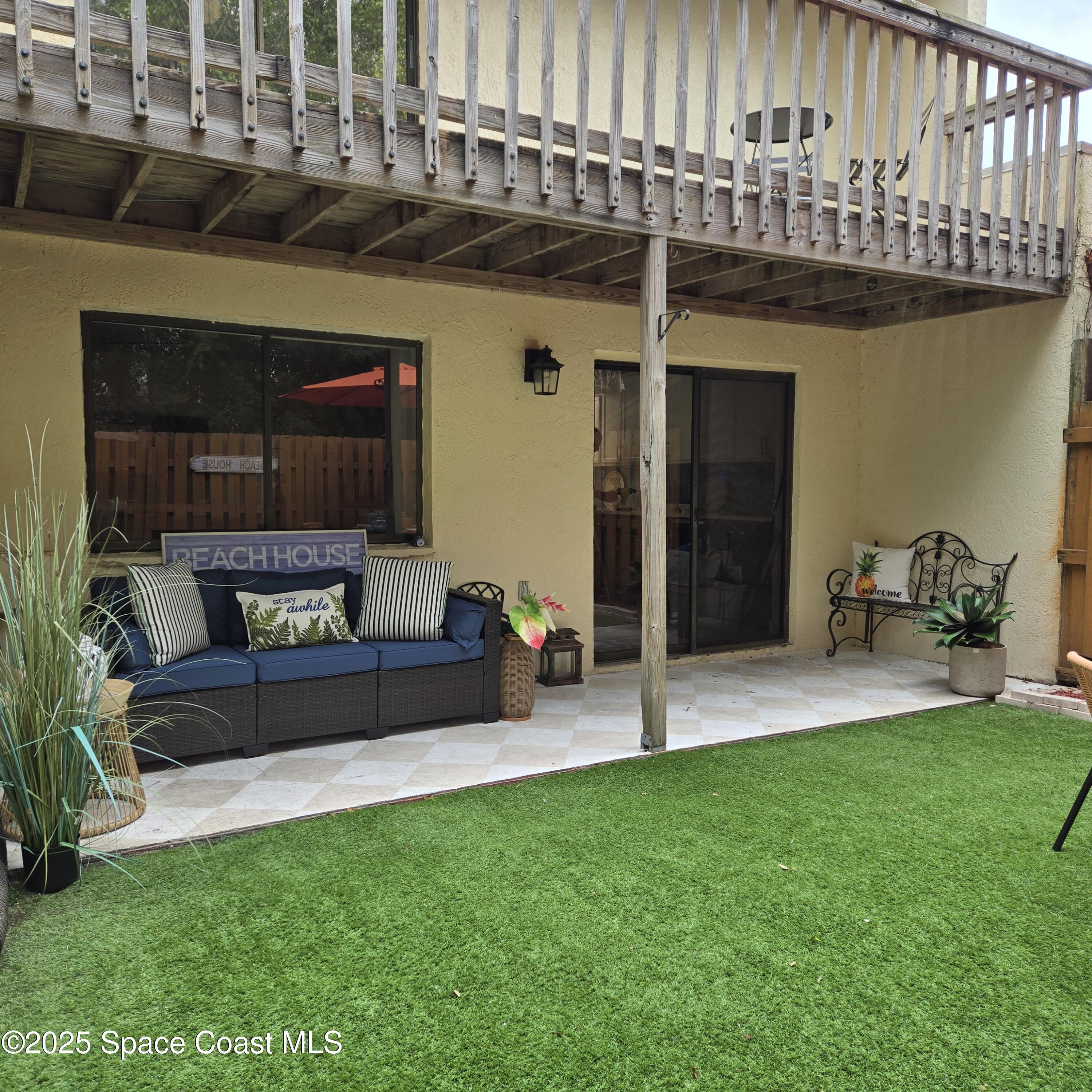 8761 Ilex Court Cape Canaveral, FL 32920 - Photo 16 of 41 a view of a house with a yard and sitting area