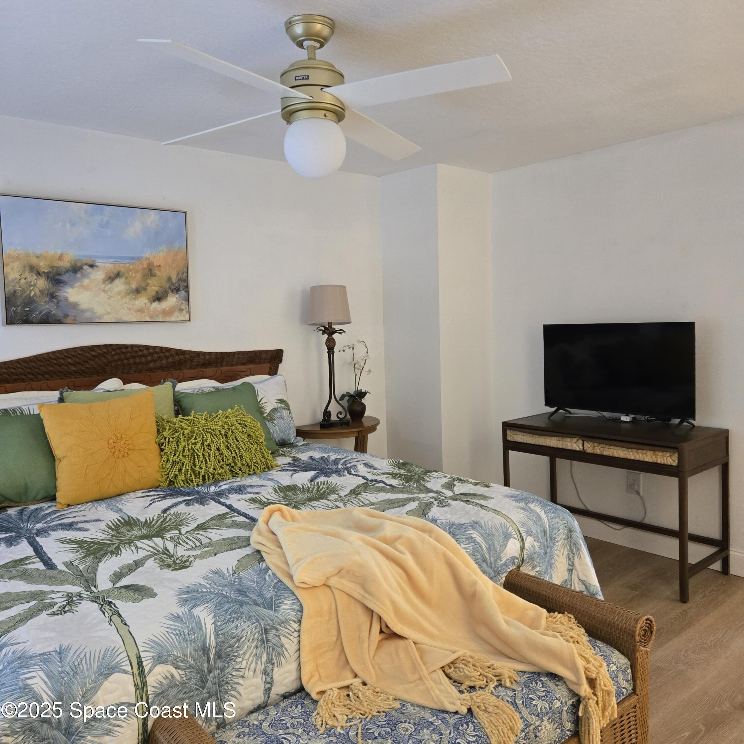 8761 Ilex Court Cape Canaveral, FL 32920 - Photo 17 of 41 a bedroom with a bed and a flat screen tv