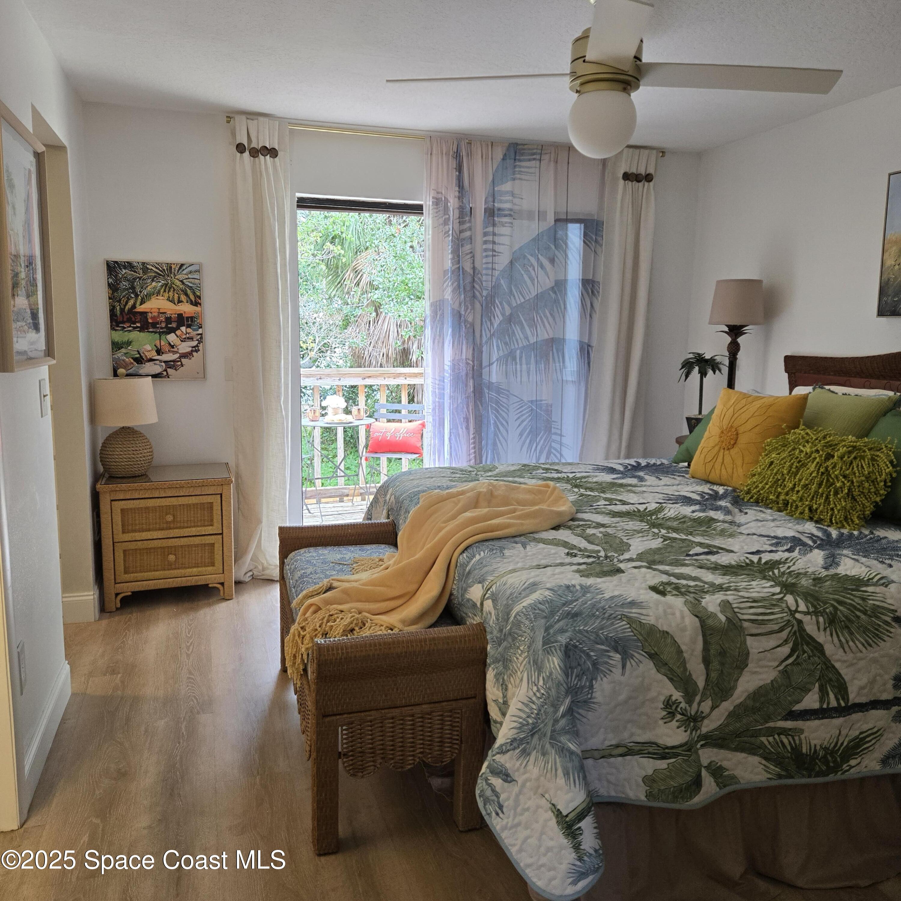 8761 Ilex Court Cape Canaveral, FL 32920 - Photo 18 of 41 a bed sitting in a bedroom next to a window