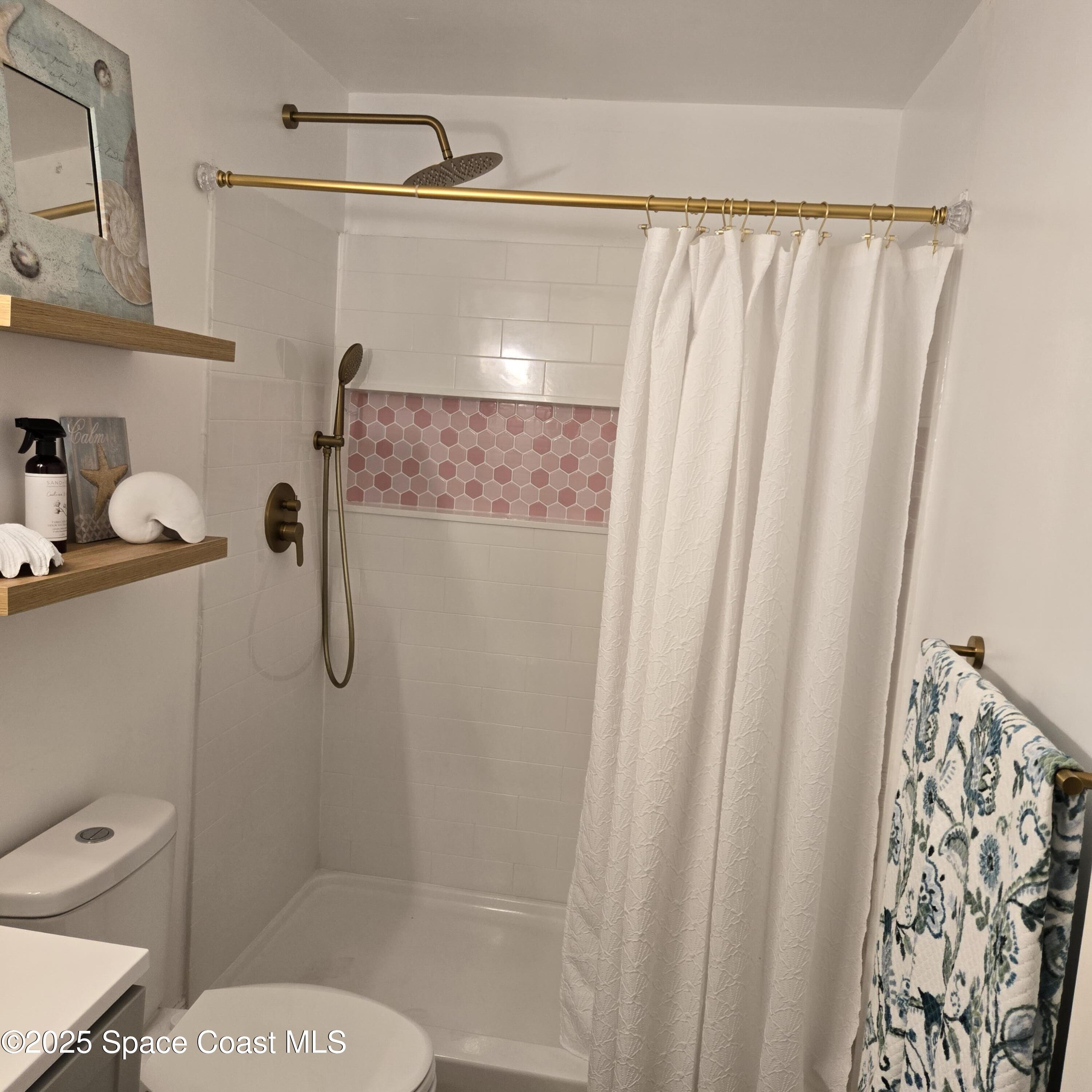 8761 Ilex Court Cape Canaveral, FL 32920 - Photo 21 of 41 a bathroom with a shower and a toilet