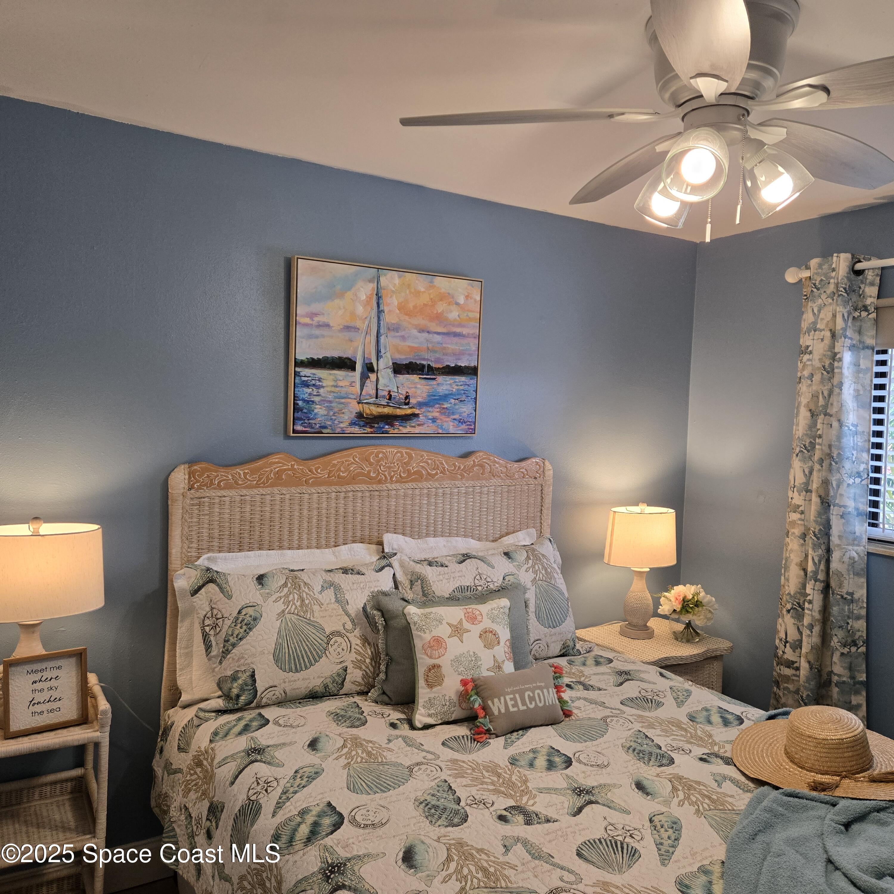 8761 Ilex Court Cape Canaveral, FL 32920 - Photo 22 of 41 a bedroom with a bed and window