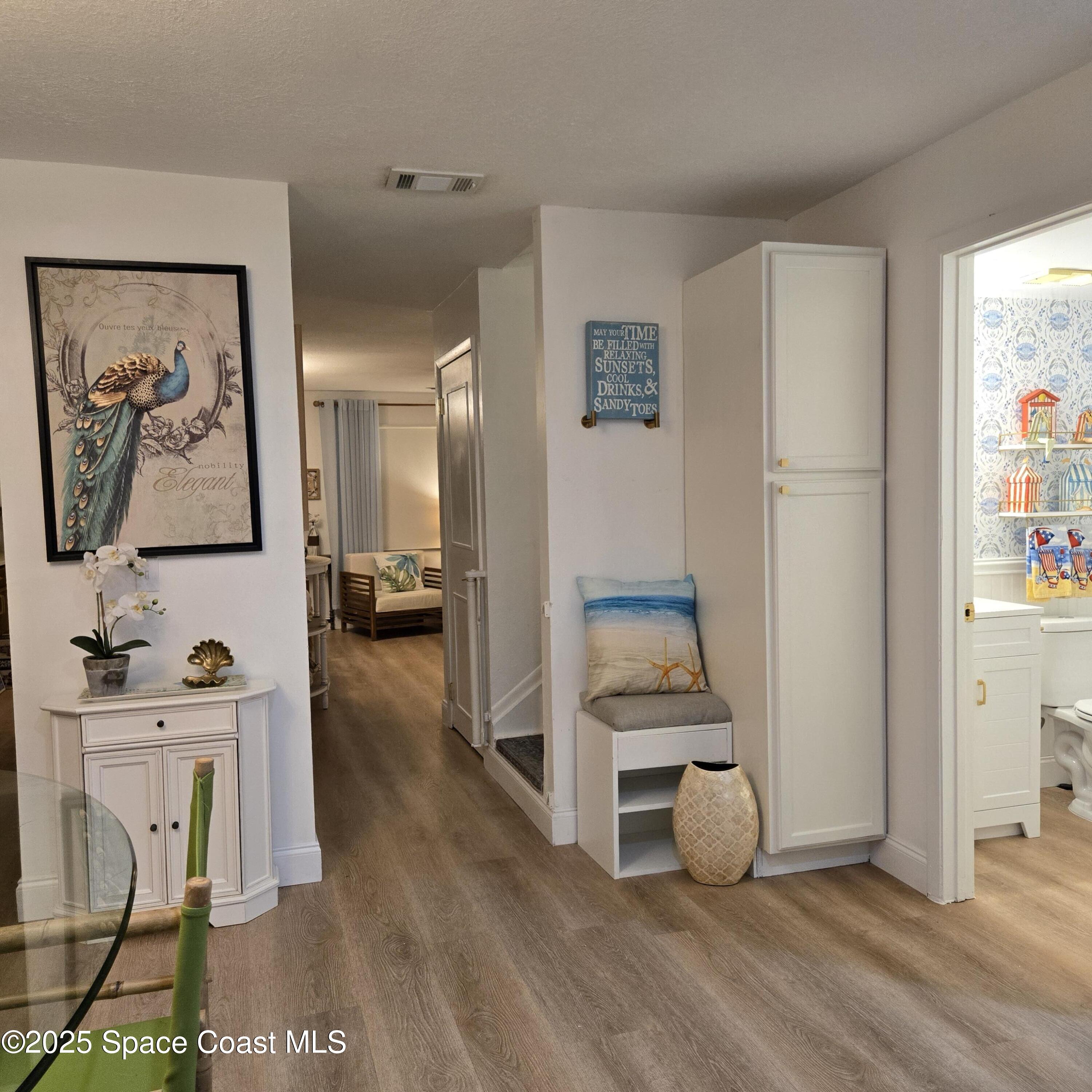 8761 Ilex Court Cape Canaveral, FL 32920 - Photo 5 of 41 a view of room with furniture and wooden floor