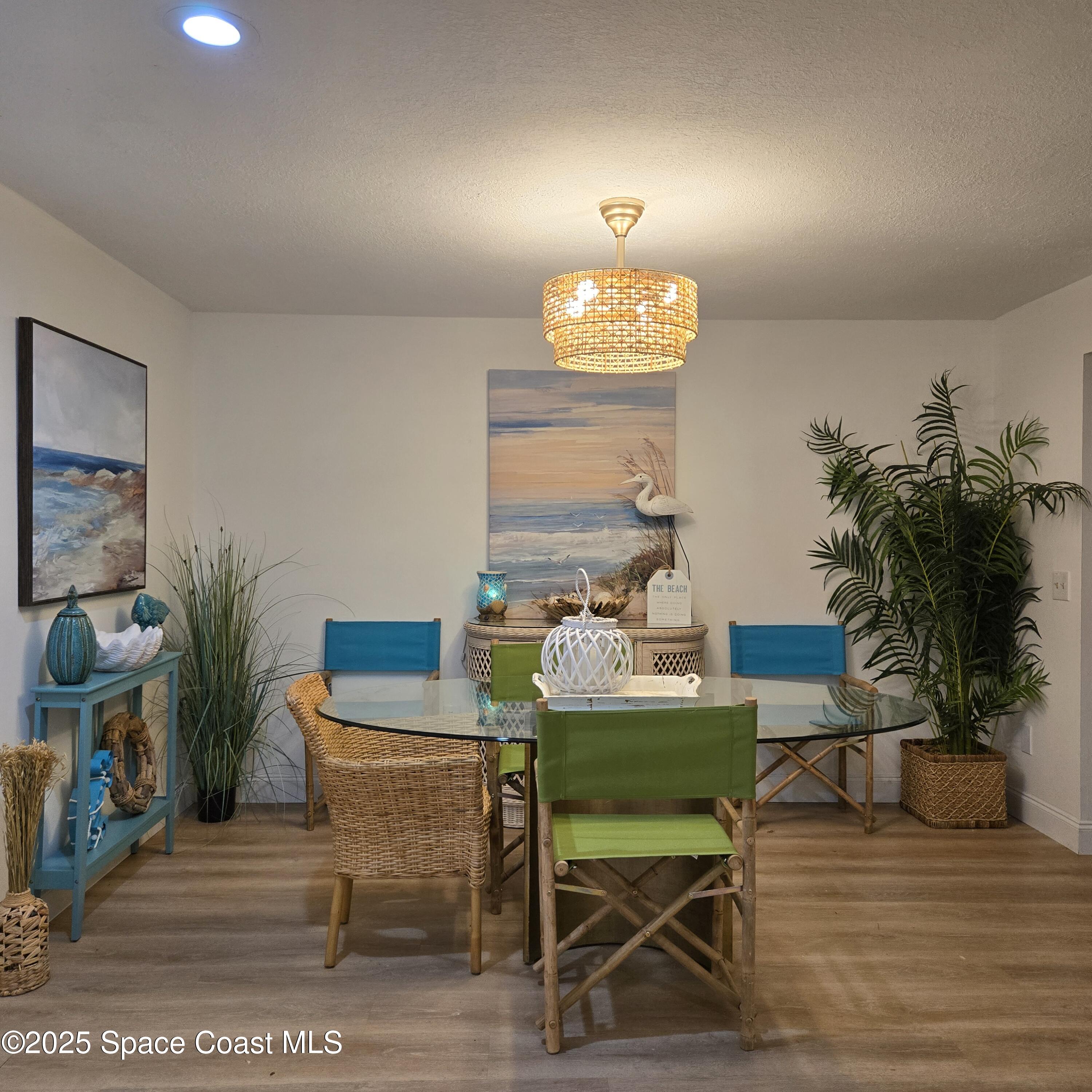 8761 Ilex Court Cape Canaveral, FL 32920 - Photo 6 of 41 a view of a dining room with furniture and wooden floor